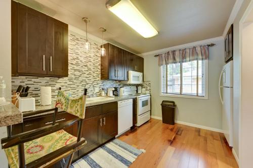 a kitchen with wooden cabinets and a refrigerator at The Homestead Apartments- Walk to SFA Campus, Comfy, Children & Pet-Friendly Nacogdoches Condo in Nacogdoches