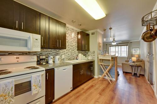 a kitchen with wooden cabinets and white appliances at The Homestead Apartments- Walk to SFA Campus, Comfy, Children & Pet-Friendly Nacogdoches Condo in Nacogdoches