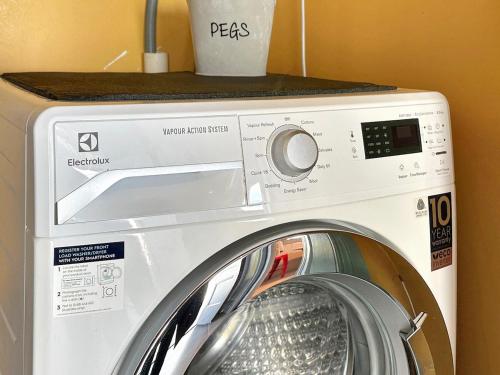 a washing machine with a counter on top of it at The Settlers Cottage - In the Heart of St Helens in St Helens