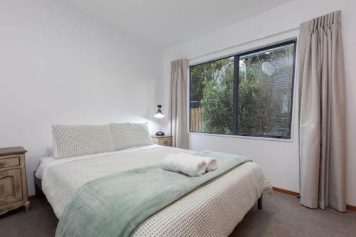 a bedroom with a bed and a window at Central Methven Chalet, 3 Bedroom, Family Friendly in Methven