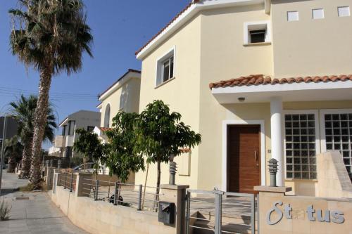 a white house with a fence in front of it at Villa Christina in Paphos