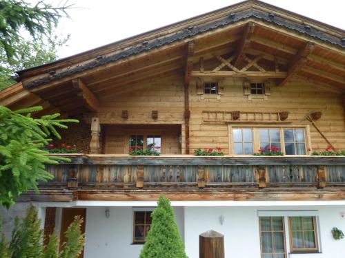 a wooden house with a balcony on top of it at Ferienhaus Stubaiblick in Neustift im Stubaital