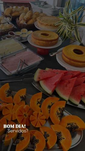 a table full of different types of fruit on plates at Pousada Ray Sol - Centro Arraial d Ajuda in Arraial d'Ajuda