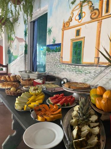a buffet with many different types of food on a table at Pousada Ray Sol - Centro Arraial d Ajuda in Arraial d'Ajuda