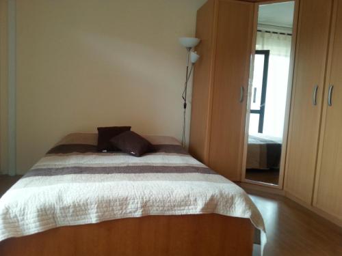 a bedroom with a bed and a large mirror at Ana Tudor Apartments in Hvar