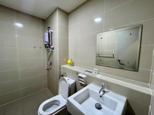 a bathroom with a sink and a toilet and a mirror at SUTERA AVENUE 2BEDROOM B8 by GC near imago kk in Kota Kinabalu