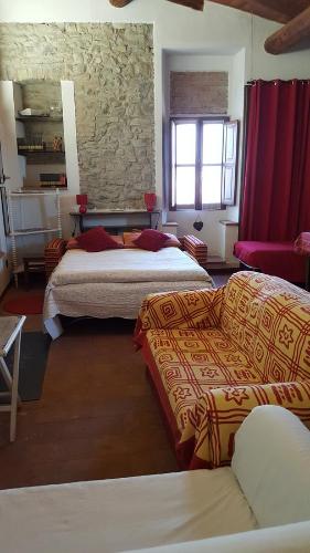 a hotel room with two beds and a couch at La Torretta - Cerreto Grue in Sarezzano