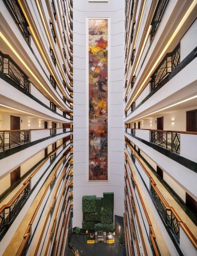 a view of the lobby of a building with art on the walls at Grand Mercure Shanghai Hongqiao in Shanghai