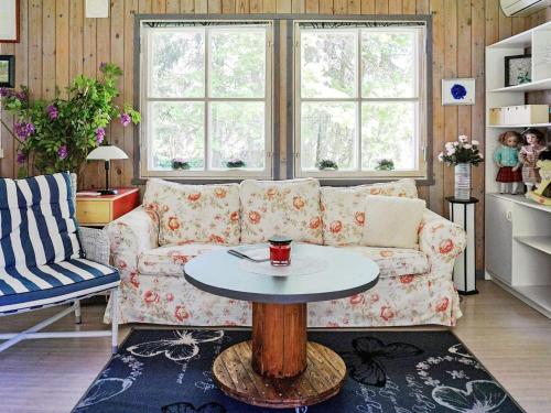 a living room with a couch and a table at 4 person holiday home in Hemse in Hemse
