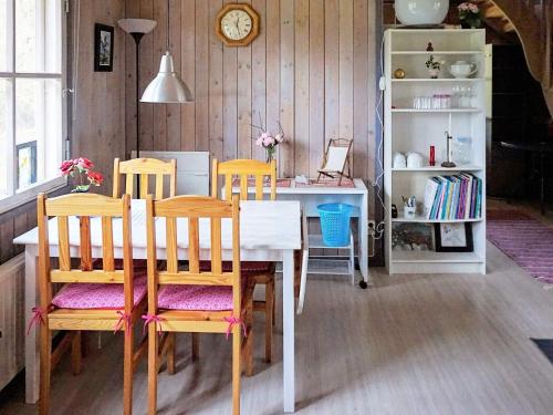 a dining room with a table and chairs and a desk at 4 person holiday home in Hemse in Hemse