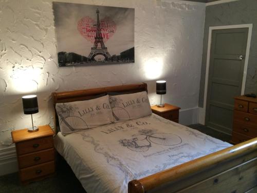 a bedroom with a bed with drawings on the bedspread at Somerset House Apartments in Blackpool