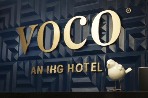 a sign that says yooc an hdb hotel at voco Saltillo Suites by IHG in Saltillo