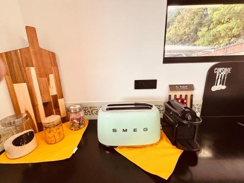 a counter with a toaster on a table at Airport Pamatai Room in Faaa