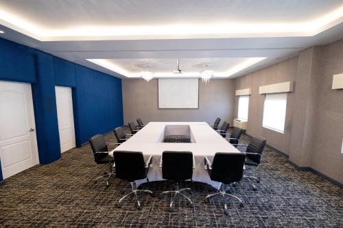 a conference room with a large table and chairs at voco Saltillo Suites by IHG in Saltillo