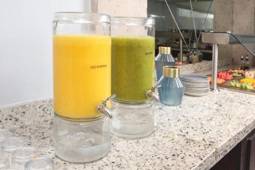 two containers of juice sitting on a kitchen counter at voco Saltillo Suites by IHG in Saltillo