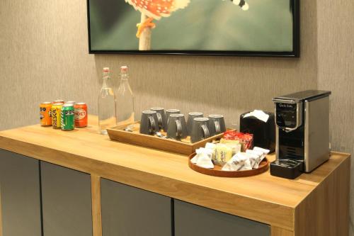 a counter in a hotel room with a coffee maker and a microwave at voco Saltillo Suites by IHG in Saltillo