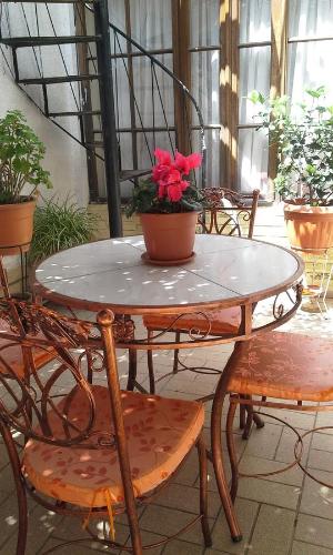 a table and chairs with a potted plant on it at Casa de Huespedes Isabella in Sucre