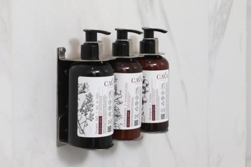 three bottles of hair products in a refrigerator at voco Saltillo Suites by IHG in Saltillo