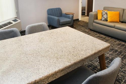 a table and chairs in a waiting room at voco Saltillo Suites by IHG in Saltillo