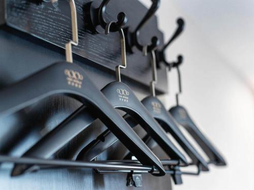 a row of cooking utensils hanging from a wall at Xi'an Hotel, Shenzhen Luohu East Gate Yitian Holiday Plaza in Shenzhen