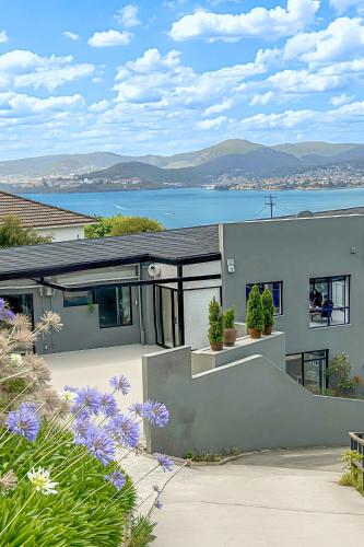 a house with a view of the water at 4 bedrooms luxury Sea View Family retreat in Sandy bay in Hobart