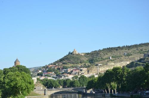a hill with a town on top of it at Aparthotel Mari in Tbilisi City