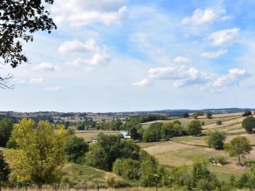 a view of the countryside from a hill with trees at Holiday Home in Luzy with Fenced Garden in Cuzy
