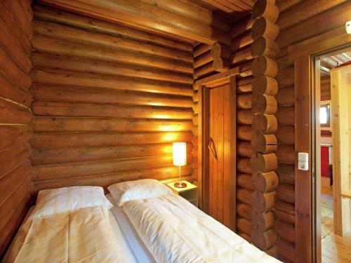 a log cabin with a bed in a room at Chalet in Wörgl near SkiWelt Wilder Kaiser in Salvenberg