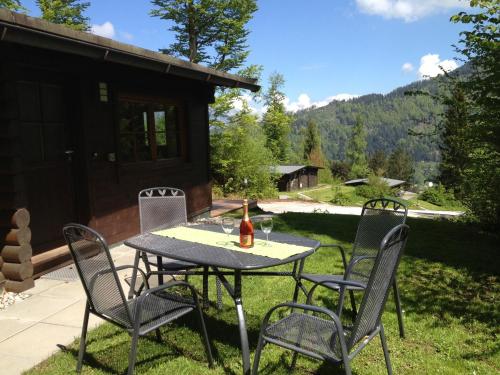 a table with chairs and a bottle of wine on it at Chalet in Wörgl near SkiWelt Wilder Kaiser in Salvenberg