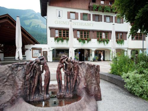 a statue of two people in front of a building at Chalet in Wörgl near SkiWelt Wilder Kaiser in Salvenberg