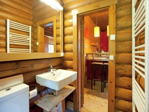 a bathroom with a white sink and a table at Chalet in Wörgl near SkiWelt Wilder Kaiser in Salvenberg