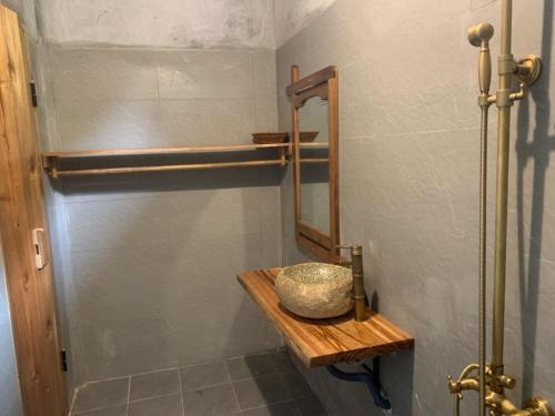 a bathroom with a sink and a mirror at Pác Bó Boutique Hotel in Cao Bằng
