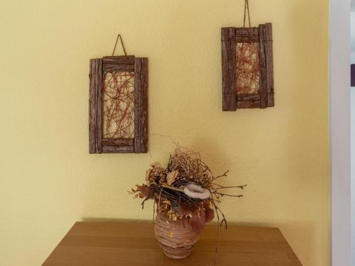 a vase sitting on a table with two stained glass windows at Cozy Family Apartment in Braunichswalde