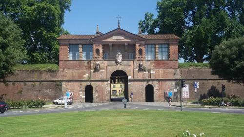 a brick building with a car parked in front of it at Tangohotel in Lucca
