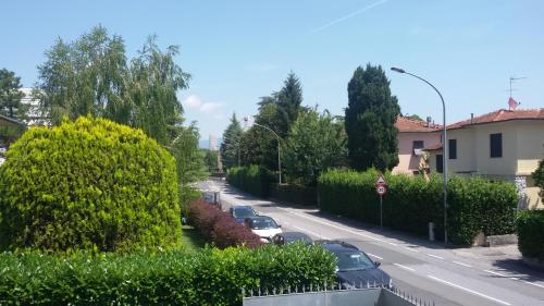 a street with cars parked on the side of a road at Tangohotel in Lucca
