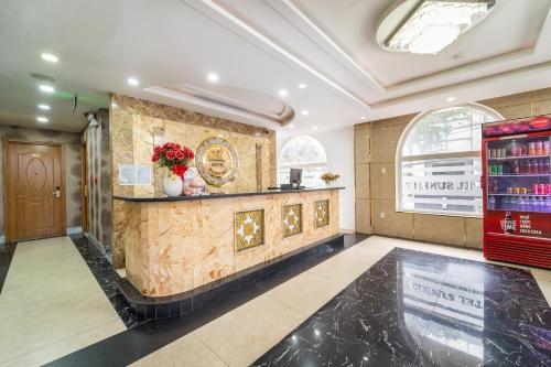 a large room with a counter with flowers on it at Collection O Sunrise Hotel Trung Son Near Lotte Mart in Ho Chi Minh City