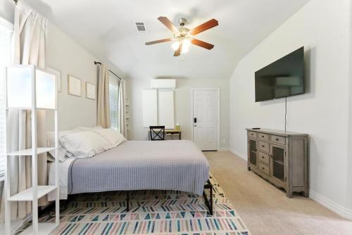 a bedroom with a bed and a ceiling fan at Cozy Studio Mins to JPS, Medical City, Historic District, Zoo, Water Garden in Fort Worth
