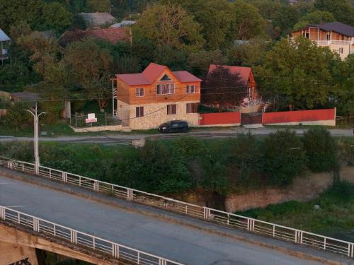 a house on the side of a road next to a bridge at Sionis Idilia in Sioni