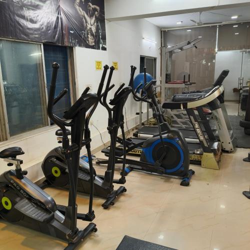 a gym with several cardio machines in a room at Hotel Times Stay in Udaipur