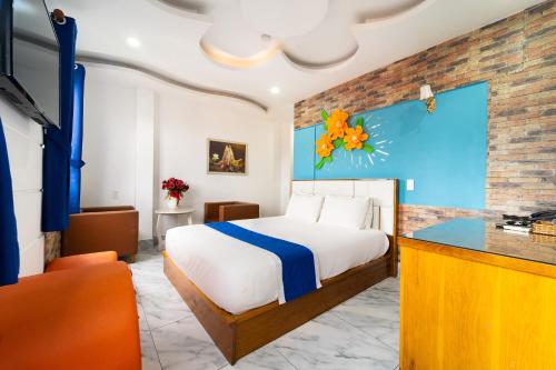 a bedroom with a bed and a large window at Collection O Sunrise Hotel Trung Son Near Lotte Mart in Ho Chi Minh City