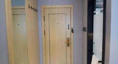 a door in a room with two different doors at Green Tree Inn Urumqi San'gong Metro Station Exit in Ürümqi