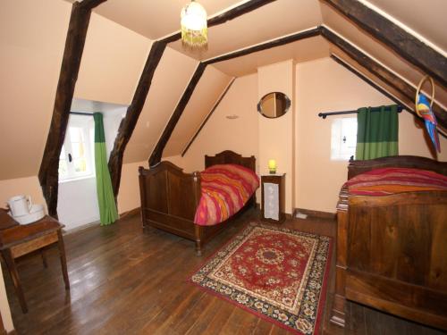 a bedroom with two beds and a large mirror at Holiday Home in Saint-Geniez-d'Olt near Lot River in Saint-Geniez-dʼOlt