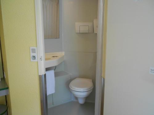 a small bathroom with a toilet and a sink at Premiere Classe Brest Gouesnou Aeroport in Gouesnou