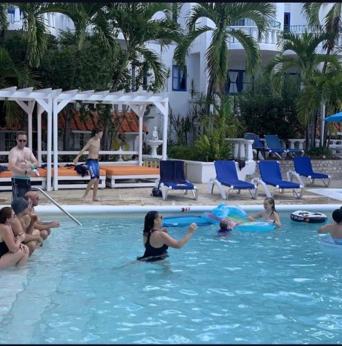 a group of people playing in a swimming pool at Ocean Tropical Escape 1BR 1BA Ocean view in Runaway Bay