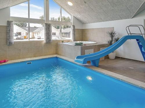 a swimming pool with a slide in a bathroom at 5 star holiday home in Kappeln in Kappeln