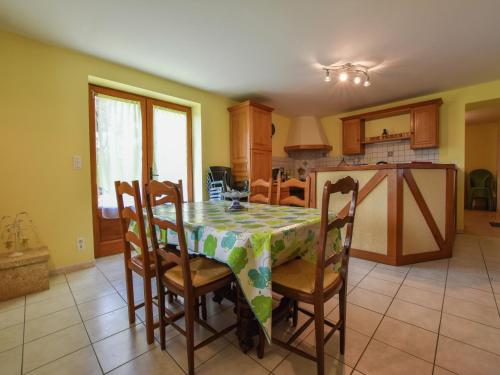 a kitchen with a table and chairs with a tablecloth at Holiday home with private garden in Cazals
