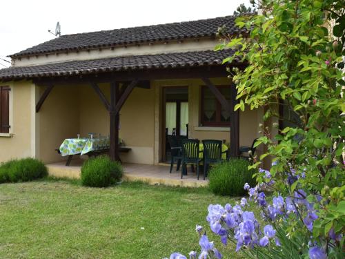 a patio of a house with a table and chairs at Holiday home with private garden in Cazals
