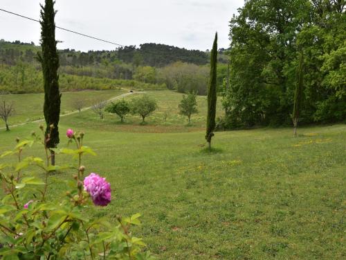 a field with a pink flower in the grass at Holiday home with private garden in Cazals