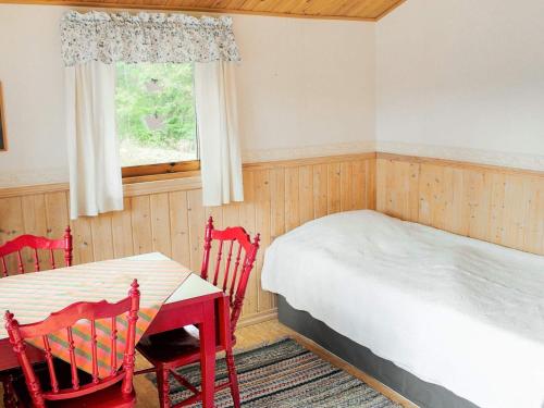 a bedroom with a bed and a table and chairs at 6 person holiday home in TROLLHÄTTAN in Trollhättan