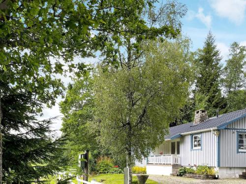 a house with a tree in front of it at 6 person holiday home in TROLLHÄTTAN in Trollhättan